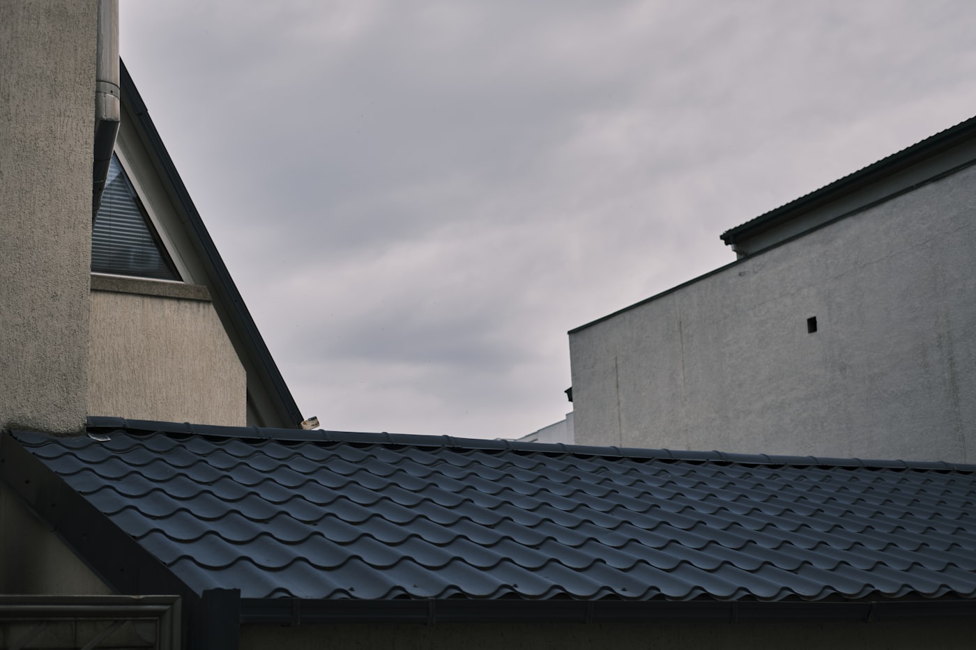 Dark metal roofline against an overcast Tennessee sky. TODO: replace with a Bill Ragan storm project photo.
